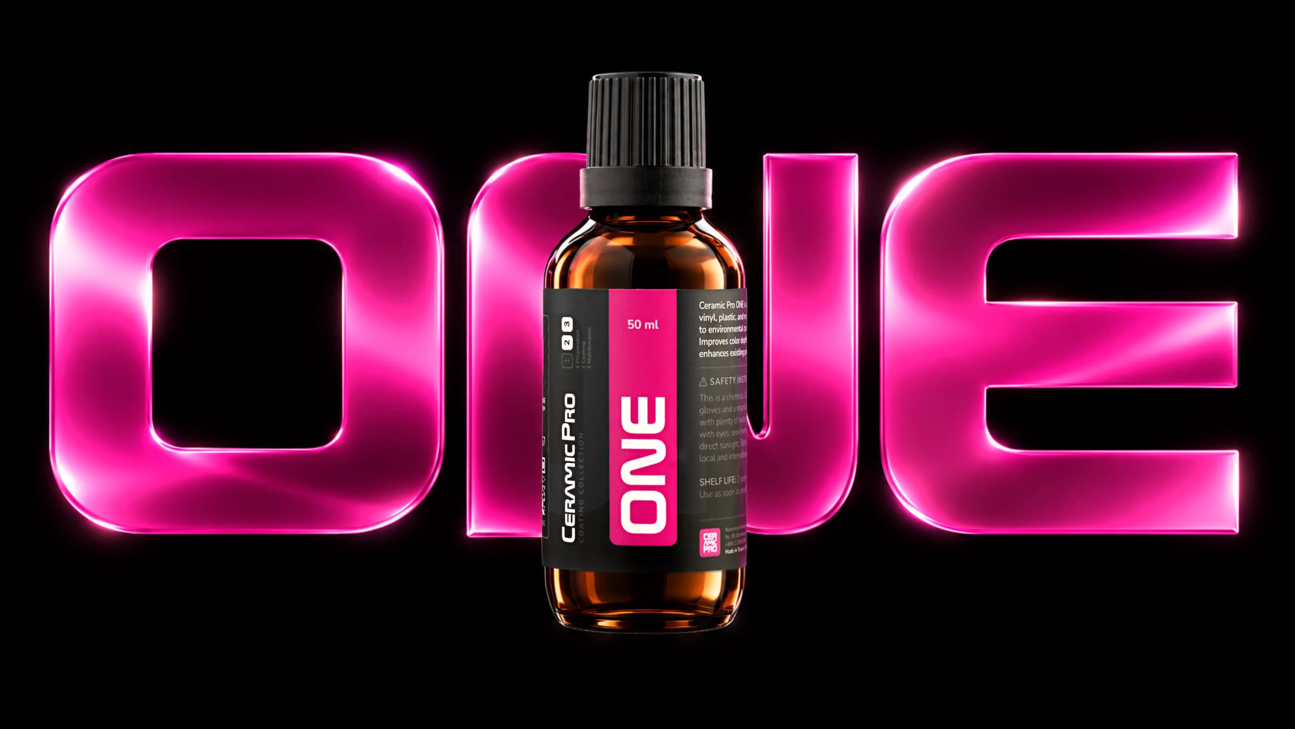 Ceramic Pro ONE bottle in front of large pink ONE letters