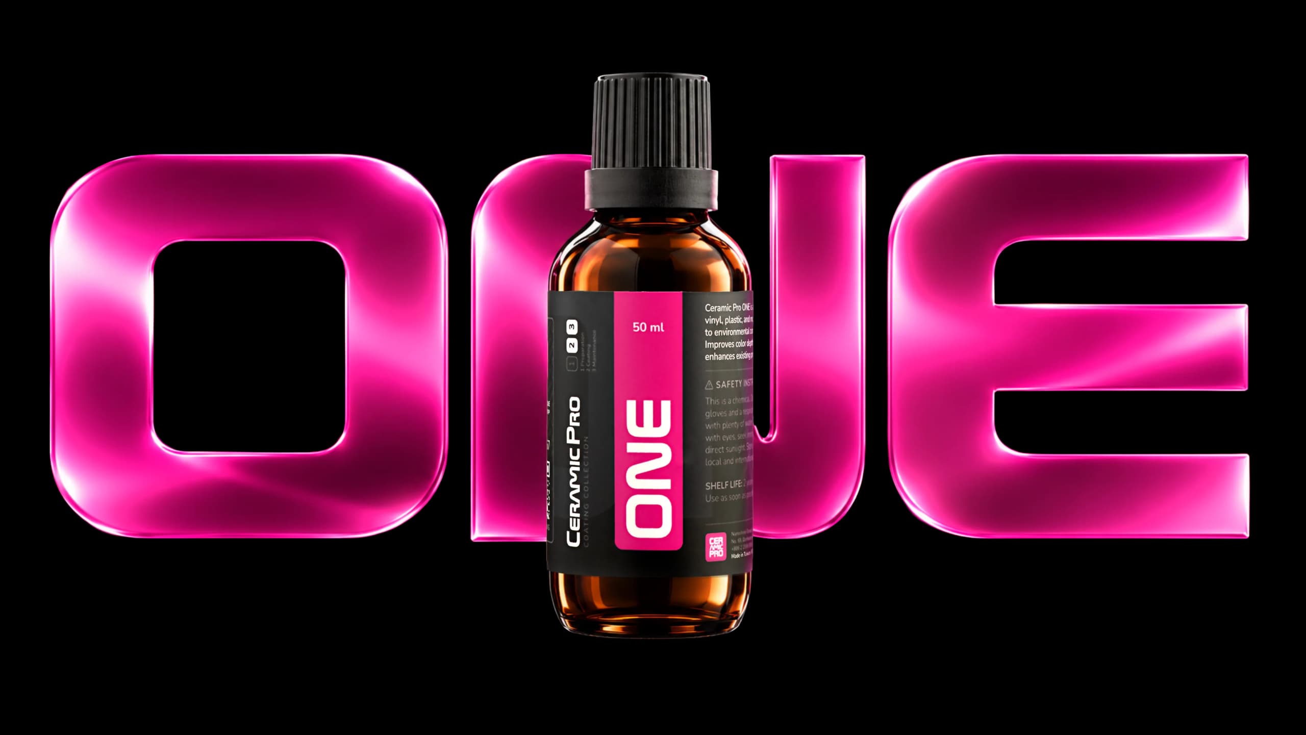 Ceramic Pro ONE bottle in front of large pink ONE letters